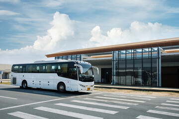 The passenger white bus is parking  near airport.  bus transport, tourism transportation, travel concept. © Sergey