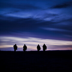 Fototapeta na wymiar Soldiers walking at dusk silhouette, their forms fading into the darkening blues and purples of the sky. The peaceful serenity of the evening is juxtaposed with the gravity of their situation.