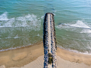 Aerial view landscape. Italy Pescara. Sea, waves, sand , empty beach, stones.