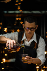 Barman pouring whiskey whiskey glass beautiful night