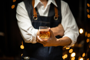 Barman pouring whiskey whiskey glass beautiful night