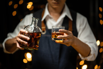 Barman pouring whiskey whiskey glass beautiful night