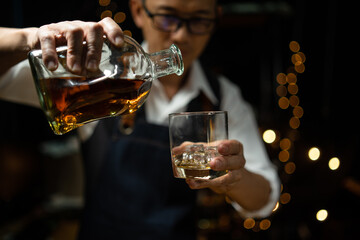 Businessman sitting and holding glass of whiskey