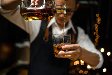 Barman pouring whiskey whiskey glass beautiful night