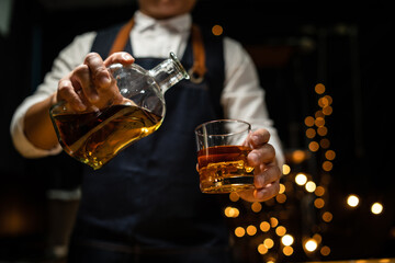 Barman pouring whiskey whiskey glass beautiful night