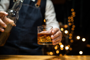 Barman pouring beer glass beautiful night