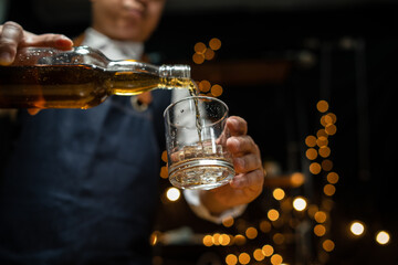Barman pouring whiskey whiskey glass beautiful night