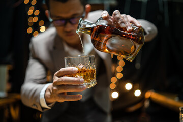 Barman pouring whiskey whiskey glass beautiful night