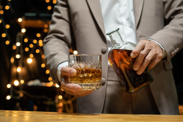 Barman pouring whiskey whiskey glass beautiful night