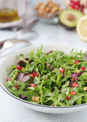 A plate with green rocket salad with pomegranate