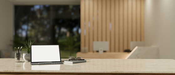 Workspace with tablet mockup on tabletop in a modern hotel or office lobby