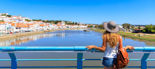 Woman tourist looking at panoramic view of  Alcacer do sal, touristic village in Portugal- Alentejo