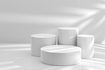Set of round white podiums with natural daylight and plant shadows on the wall.