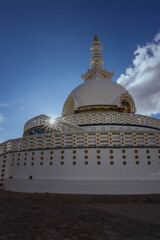 Shanti Stupa is a Buddhist monument located in Leh, India. It is a serene and majestic structure that offers panoramic views of the surrounding valley captured with sunburst.