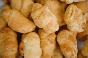 fresh croissants on a wooden board, top view