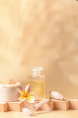 Photo sur Plexiglas Spa Auyrveda and holistic skin care cocnept. Exotic flower , massage oil bottle, sea salt and gua sha on the podium at beige background Copy space