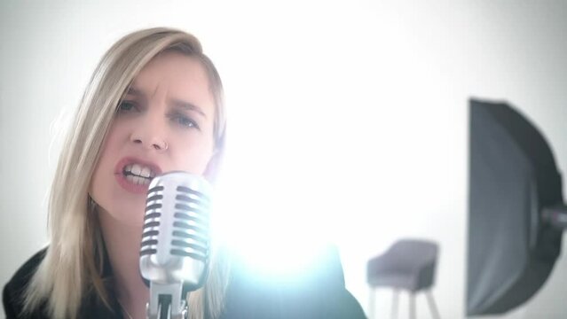 Blond Female Singer Singing Passionate Song In A Studio