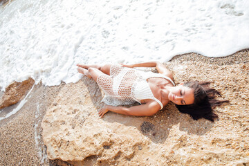 a woman lies on the seashore beach rest walk