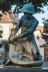 brass statue of boy and fish with well in beatiful city of erlangen