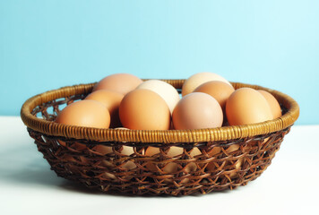 Fresh chicken eggs in a wicker basket