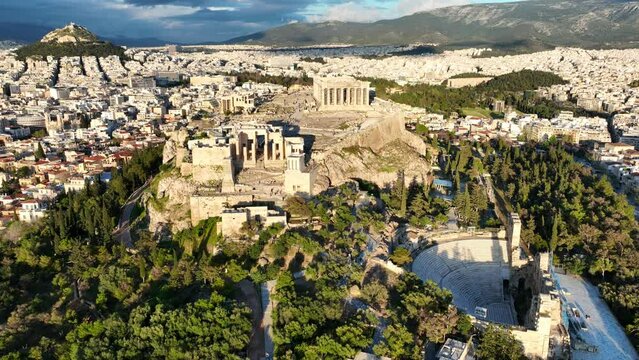 Aerial drone cinematic video of amazing Acropolis hill, the Parthenon and Propylaea entrance above Areopagus hill, a masterpiece of ancient world, Athens historic centre, Attica, Greece
