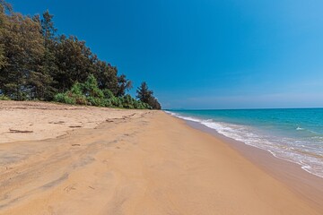 Picture of deserted Natai beach in Thailand during the day with white sand and turquoise blue water