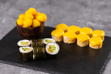 Sushi rolls set on dark background. Japanese and asian food concept
