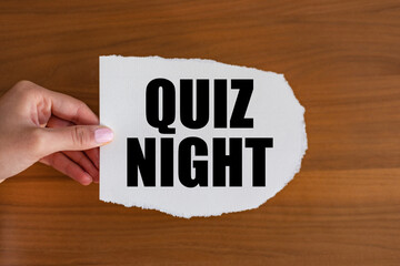 Quiz night. Woman hand holds a piece of paper with a note, quiz night. Togetherness, leisure games,...