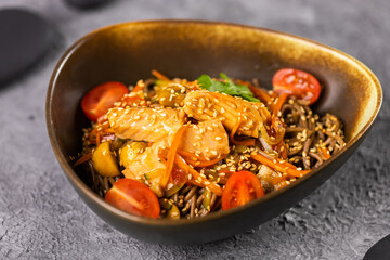 Udon stir-fry noodles with salmon and vegetables. Asian cuisine