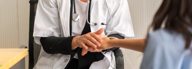 Doctor wearing uniform with stethoscope help holding hand care talk to sick woman patient checkup information, support, care, diseases, treatment in hospital.elderly healthcare