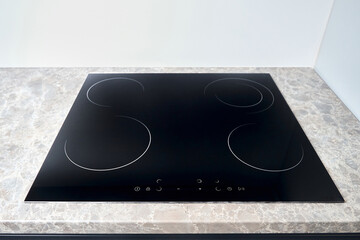 Flat cooktop cooking induction electric built black stove. Grey countertop with black glossy built...