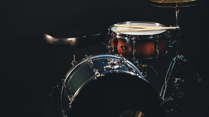 Drums on a dark background, part of a drum kit.