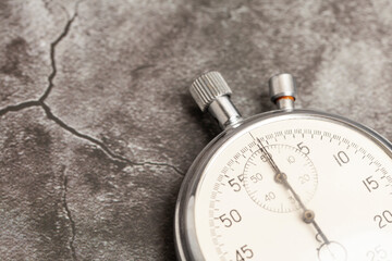 Old stopwatch on a gray background