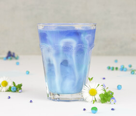 Blue matcha with milk on a light background, mermaid matcha latte