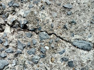 The surface of the old walkway is damaged and has cracks.