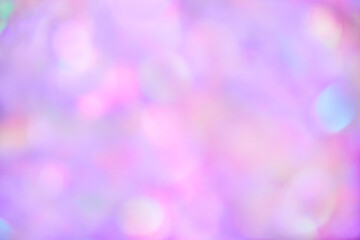 Blurred pastel neon pink, purple, mint holographic bokeh background texture. Abstract festive glittering Lo-fi retro shiny design. Smooth iridescent colors.