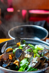 A closeup of a delicious steamed mussel casserole in a Belgian restaurant.