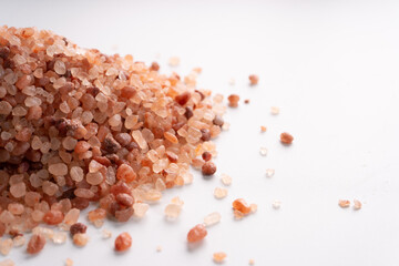Himalayan pink salt isolated on white background with copyspace
