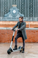 modern man sets out to ride his electro scooter near his office after a long, hard day.