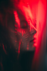 Nightmare dream. Dark consciousness. Red color light defocused tranquil woman face silhouette...