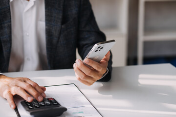 Businessman working at office with documents on his desk, doing planning analyzing the financial report, business plan investment, finance analysis concept