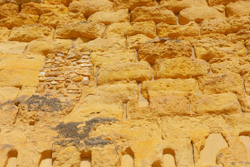 Background of ancient sandstone brick . Ruined wall texture