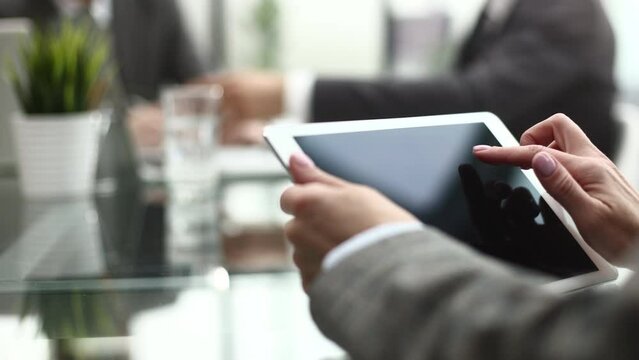 Businesswoman finger pointing to the screen of a tablet-pc