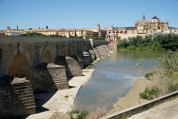 Roman bridge on Guadalquivir River and Mezquita Mosque - Cathedral in Cordoba, Spain