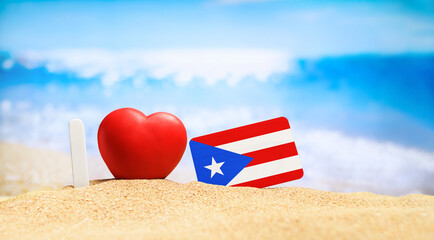 I love Puerto Rico. Flag of Puerto Rico on the beach with a red heart. vacation and travel concept.
