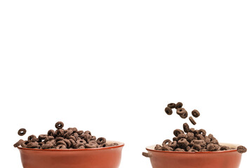 Chocolate rings cereal spill out into a bowl. Breakfast.