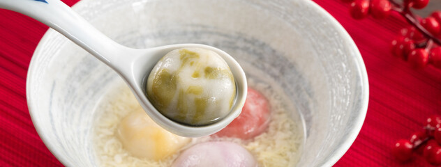 Colored glaze style big tangyuan with sweet rice wine soup and egg drop.