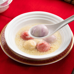 Colored glaze style big tangyuan with sweet rice wine soup and egg drop.