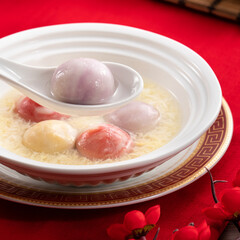 Colored glaze style big tangyuan with sweet rice wine soup and egg drop.