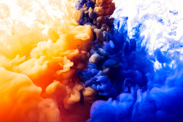 Color drop of blue and orange paint underwater paint splash abstract background